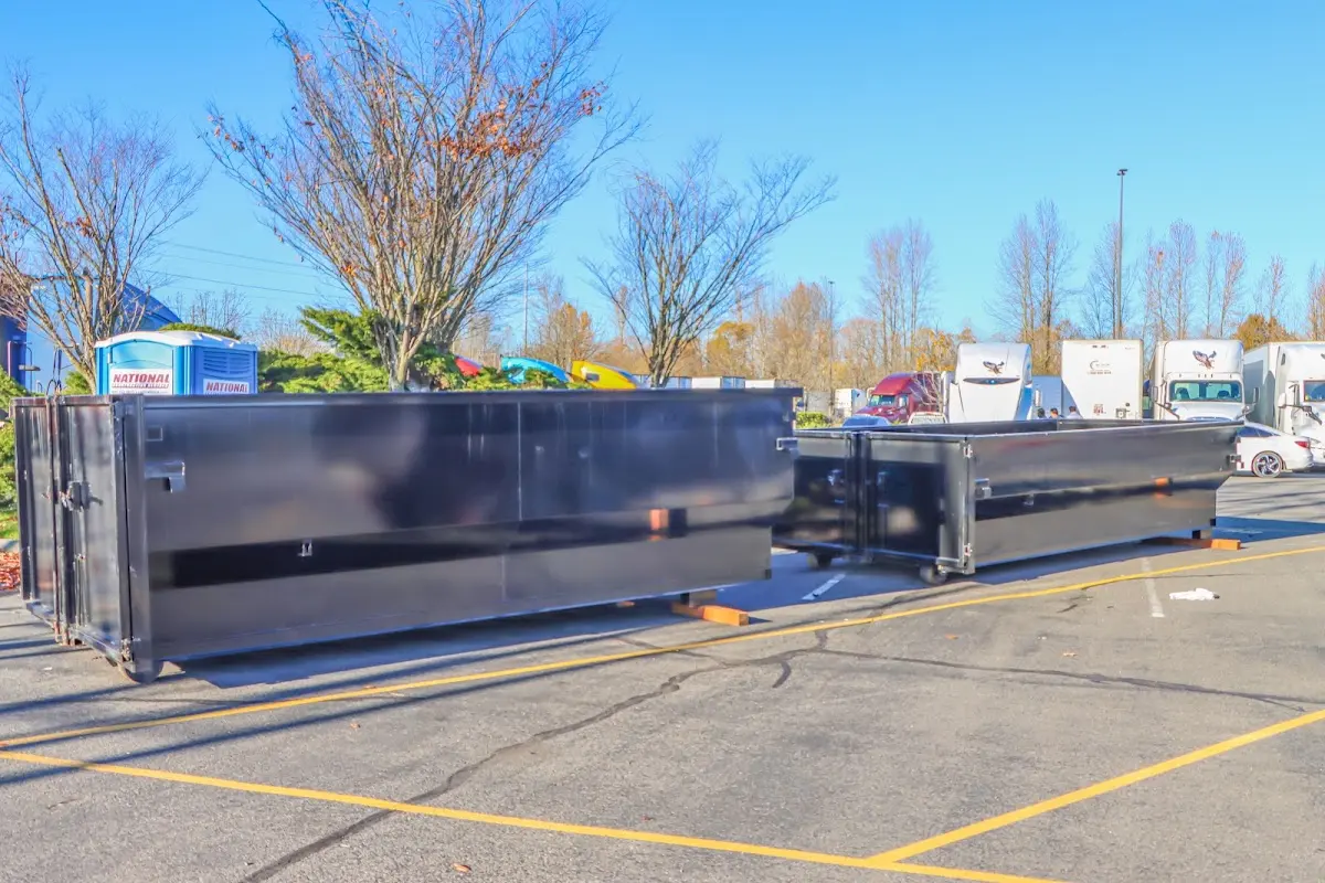 Professional dumpster rental service with roll-off container on residential driveway in Peach Bottom